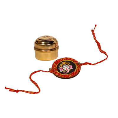 Hand designed Ganesh rakhi with roli chawal, elegantly packed in brass tin