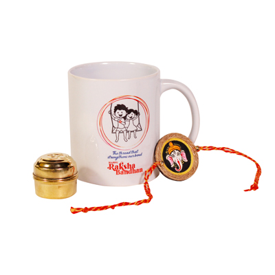Elegant Surprise Collection:Raksha Bandhan with  a Ganesh rakhi,chic white mug and brass tin with Roli chawal inside